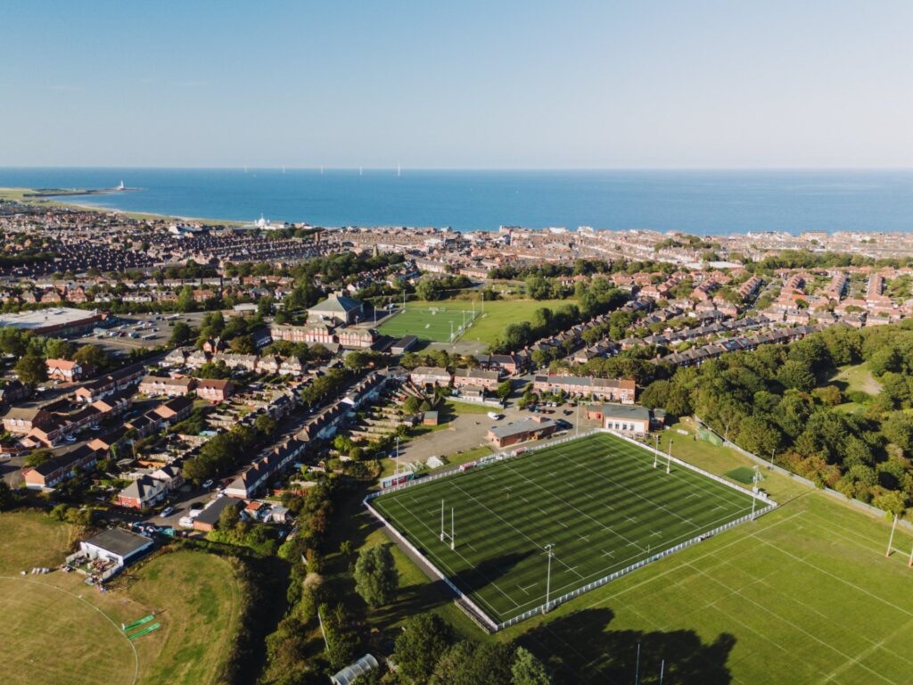 Whitley Bay Monkseaton UK: 16th Aug 2025: Whitley Bay Cricket Club, Whitley Bay Rockcliff RFC drone view. The coast is visible in the background
